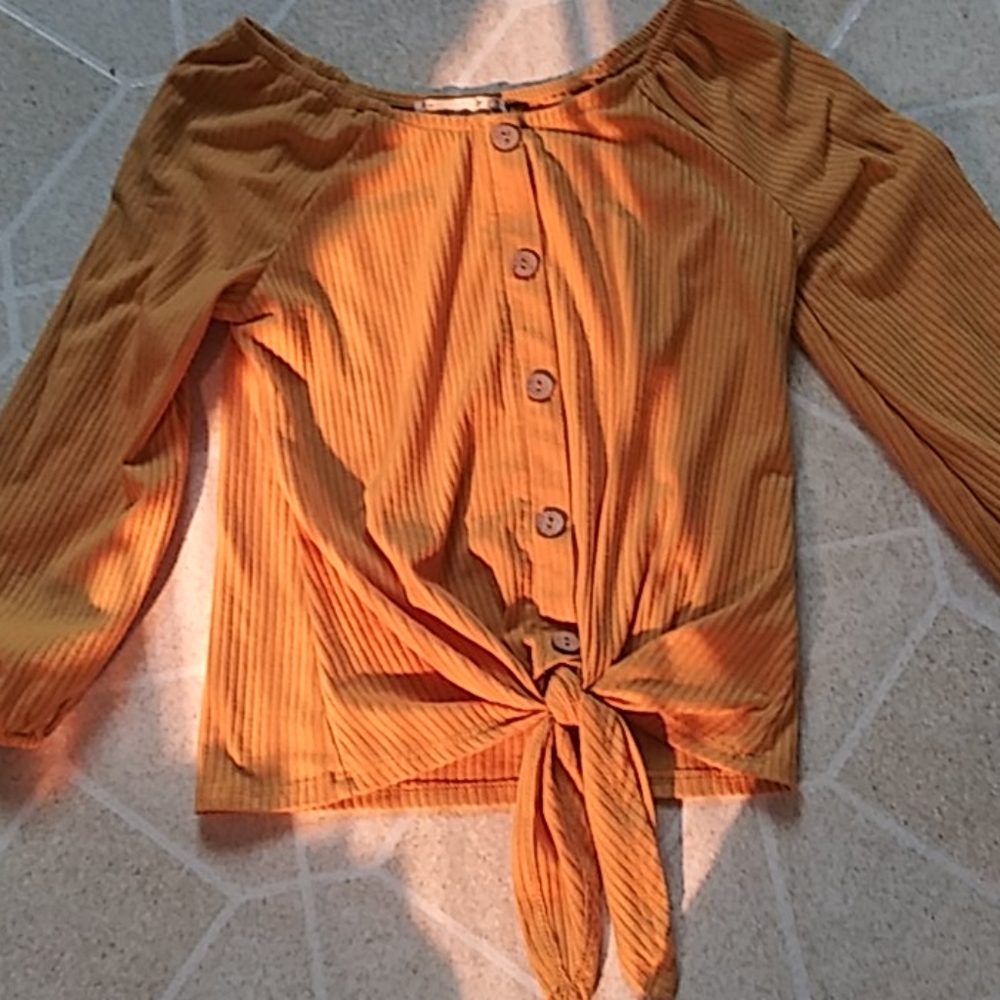 A mustard yellow shirt with buttons